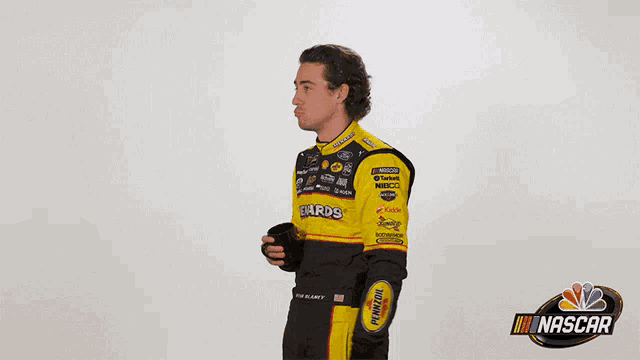 a man in a nascar uniform is holding a camera