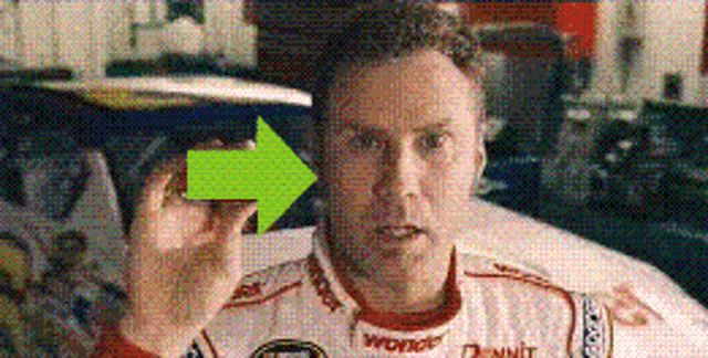 a man in a race car uniform is pointing to the right