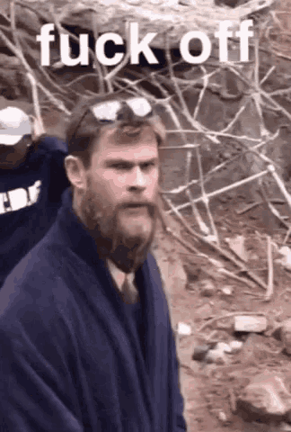 a man with a beard wearing sunglasses and a robe with the word fuck off on the bottom