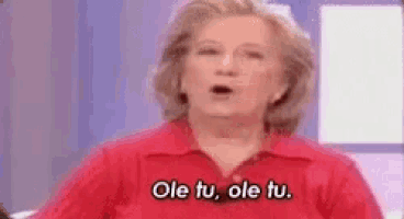 a woman in a red shirt is talking on a television show and says ole tu ole tu .