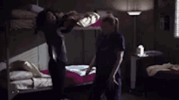 a man and a woman are dancing in a bedroom