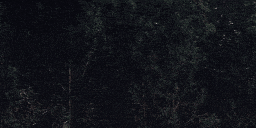 a monster with horns and sharp teeth is in the dark