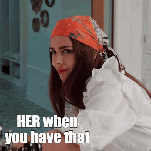 a woman wearing a head scarf and a white shirt says her when you have that