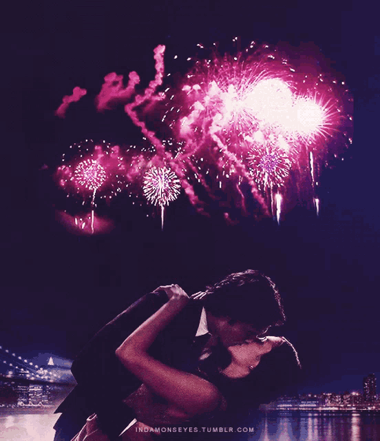 a couple kissing in front of a fireworks display with the website indamonseyes.tumblr.com below them