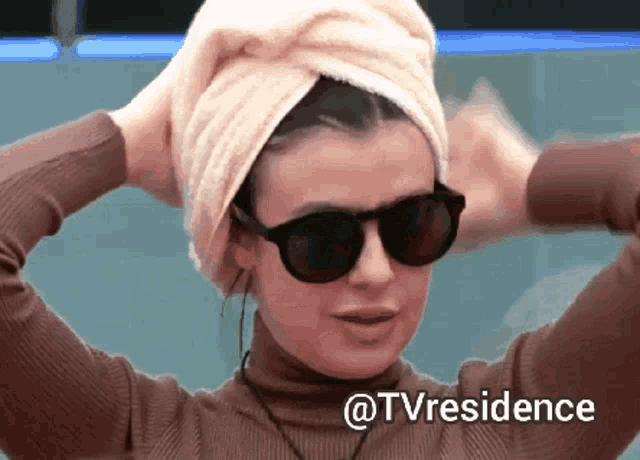 a woman wearing sunglasses and a towel wrapped around her head with the words @tvresidence below her