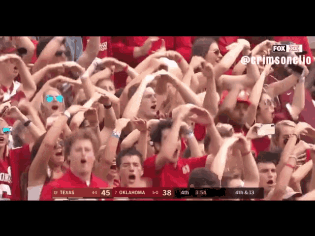 a crowd of people watching a football game with the score being texas 47 oklahoma 38