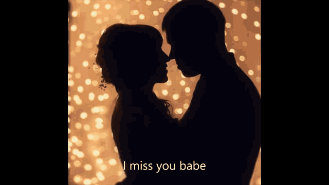 a silhouette of a man and woman kissing with the words i miss you babe above them