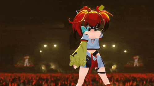 a girl with red hair is dancing on stage in front of a crowd