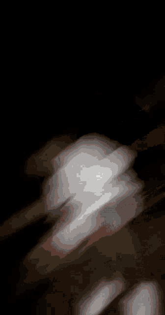 a blurry picture of a person dancing in a dark room