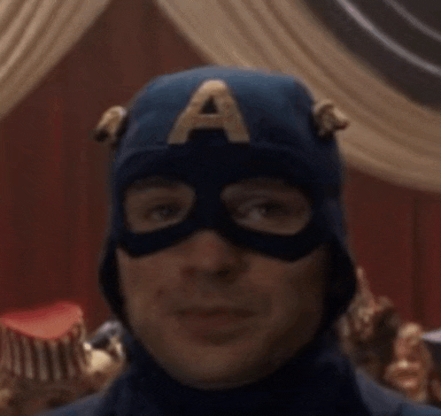 a close up of a man wearing a captain america mask