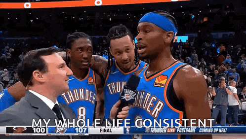 a group of basketball players are standing next to each other on a court .