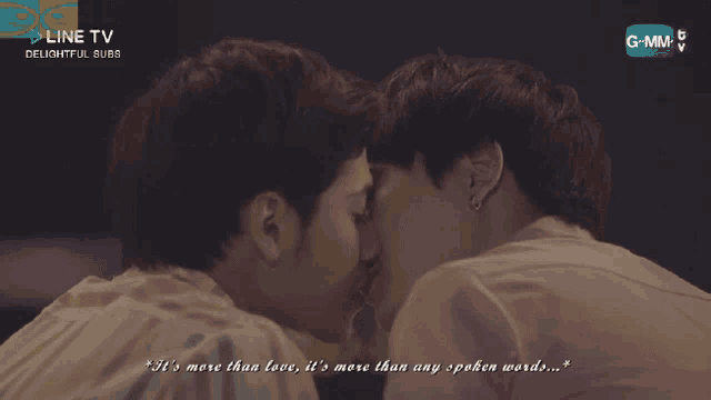 two men kissing in front of a screen that says line tv on it