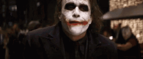 a close up of a man wearing a joker mask .