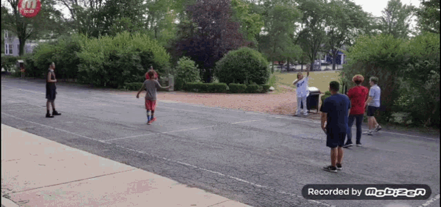 a group of boys are playing basketball in a parking lot and the video was recorded by mobizen