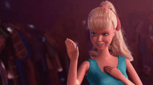 a barbie doll is wearing a blue tank top and a pink headband and smiling .