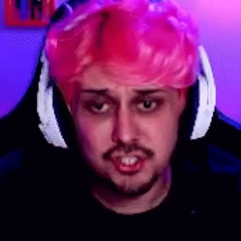 a man with pink hair and headphones is wearing a pink wig .