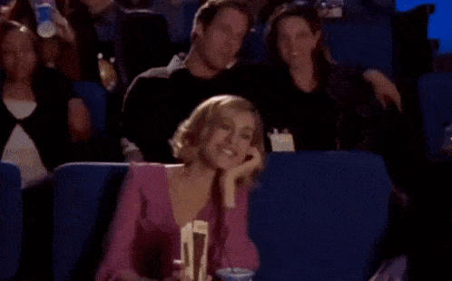a woman sitting in a theater watching a movie which was directed by charles mcdougall