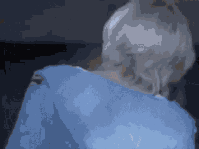 a close up of a woman 's back with a blue sweater on