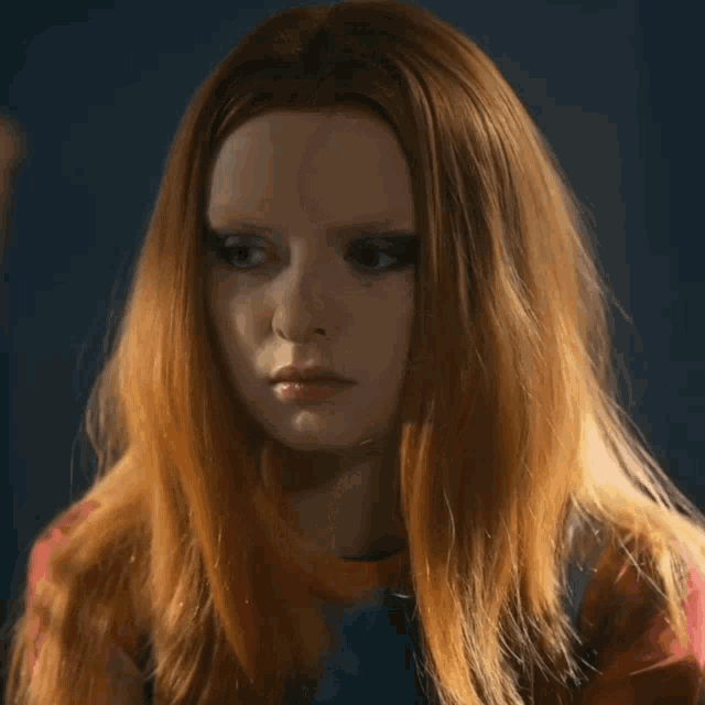 a close up of a woman with red hair