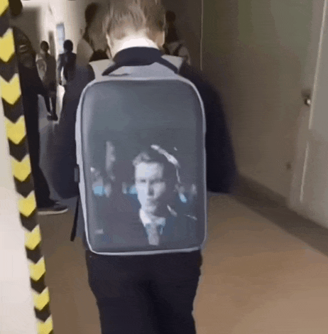 a person walking with a backpack that has a picture of a man on it