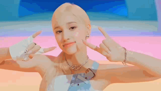 a woman with blonde hair is making a peace sign