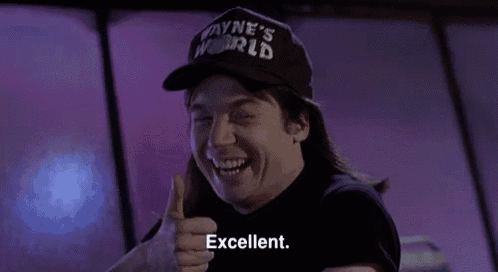wayne 's world is giving a thumbs up and smiling .