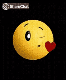 a smiley face is blowing a kiss with a red heart in front of it .