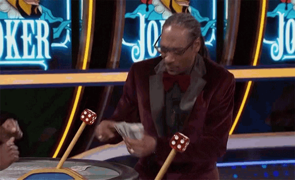 a man in a suit and bow tie is playing a game of poker