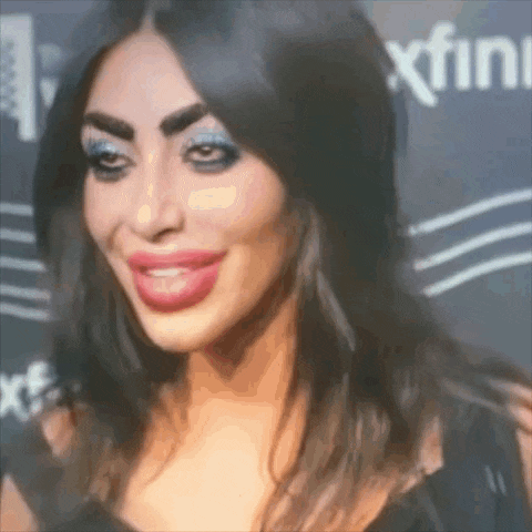 a close up of a woman 's face with a xfinity logo in the background .