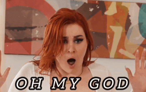 a woman with red hair says oh my god in front of a picture