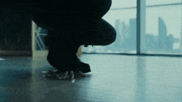 a person is kneeling down on the floor with their hands on the floor