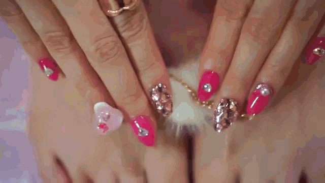 a close up of a woman 's toes with pink and gold nail polish