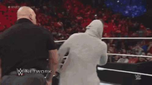 a man in a wrestling ring with a w network logo behind him
