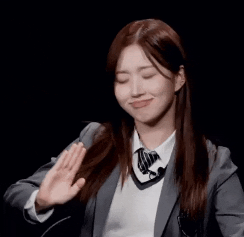 a young woman in a suit and tie is making a funny face while dancing .
