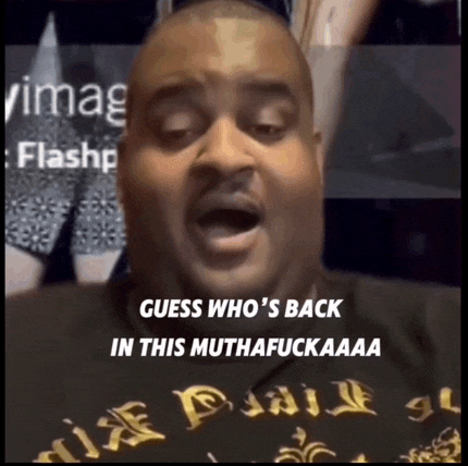 a man with a black shirt that says guess who 's back in this muthafuckaaa