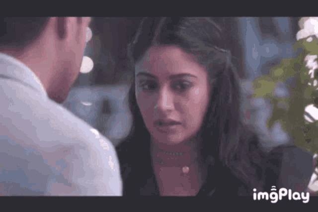 a man and a woman are looking at each other and the woman is looking at the man .