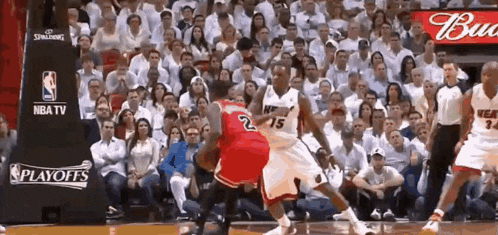 a basketball game is being played in front of a nba tv banner