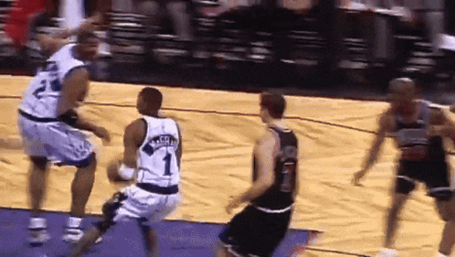a basketball player wearing a number 1 jersey is dribbling the ball