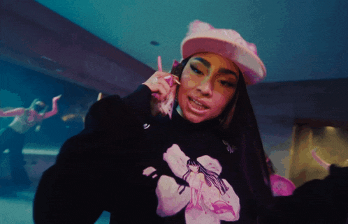 a woman wearing a pink hat is talking on a cellphone