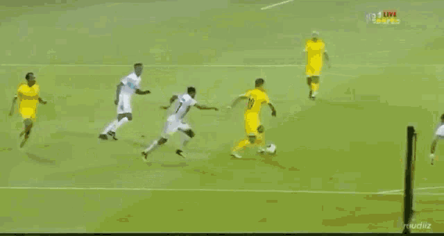 a group of soccer players on a field with a referee in the background and the word life on his shirt