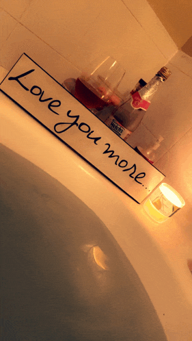 a bathtub with a sign that says " love you more " on it