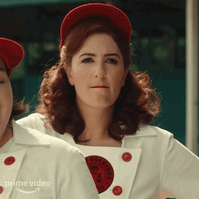 a woman wearing a red hat and a white jacket that says rockford on it