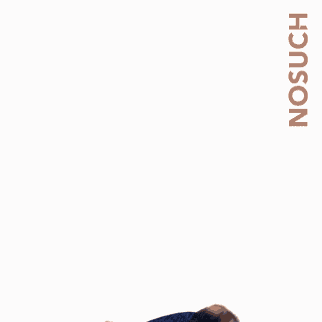 a man in a blue shirt and black jeans is standing with his arms in the air and the word no such behind him