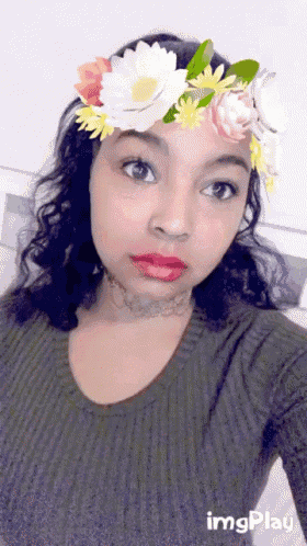 a girl wearing a flower crown takes a selfie