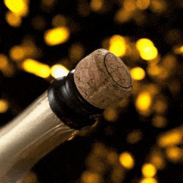 a bottle of champagne with a cork in the foreground
