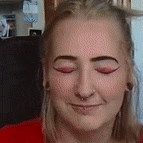 a close up of a woman with her eyes closed .