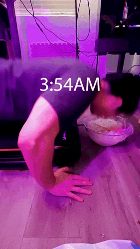 a person is doing push ups with the time of 3:54 am