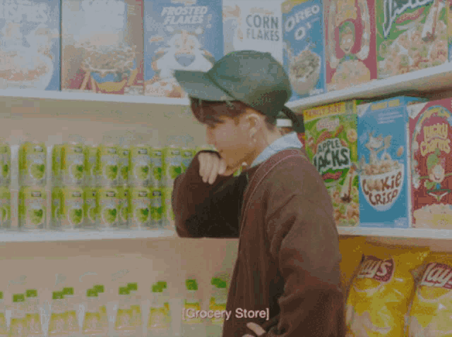 a person standing in front of a grocery store shelf full of food