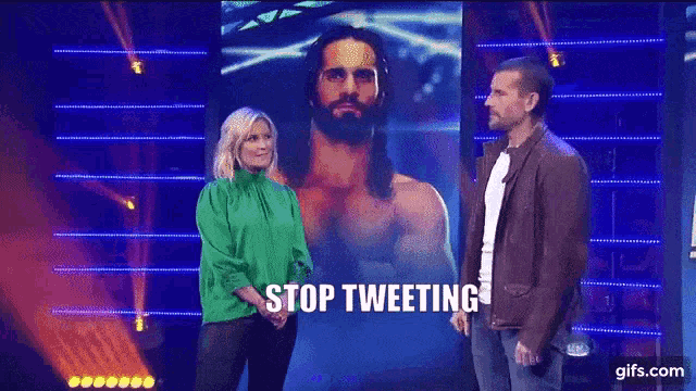 a man and a woman are standing in front of a screen that says " just stay off twitter "