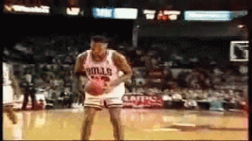 a basketball player wearing a bulls jersey is dribbling the ball